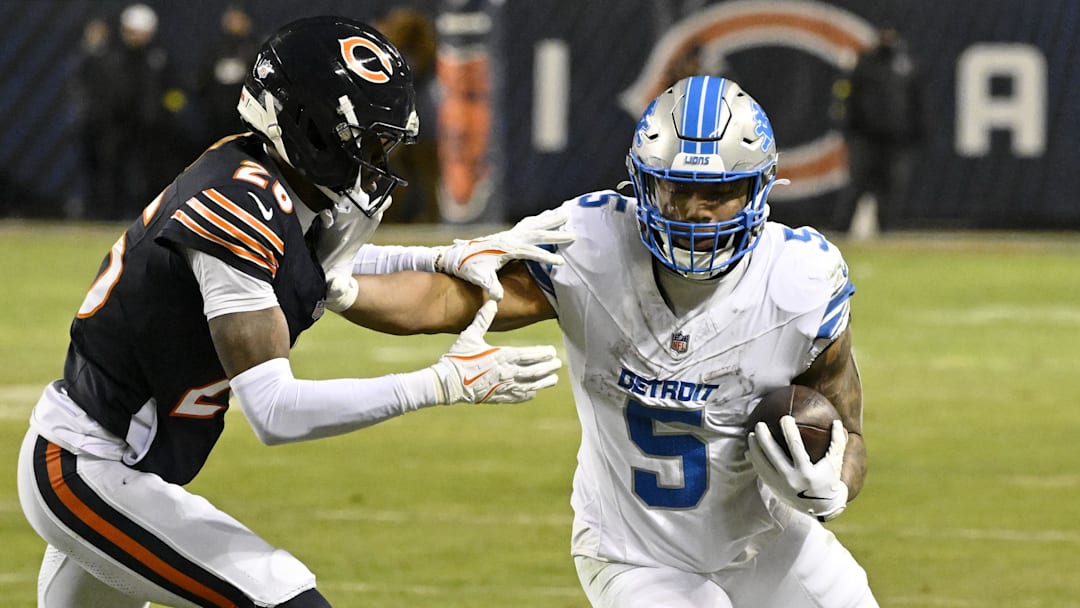 Jan 4, 2026; Chicago, Illinois, USA; Detroit Lions running back David Montgomery (5) runs with the ball against Chicago Bears cornerback Nahshon Wright (26) during the second half at Soldier Field. Mandatory Credit: Matt Marton-Imagn Images