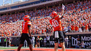 Sep 27, 2025; Stillwater, Oklahoma, USA; Oklahoma State Cowboys tight end Josh Ford (40) and Oklahoma State Cowboys wide receiver Shamar Rigby (7) celebrate in the end zone after a touchdown during the first half against the Baylor Bears at Boone Pickens Stadium. Mandatory Credit: William Purnell-Imagn Images