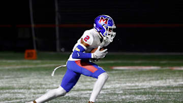 Monroe’s Messiah Amare Hampton returns a kickoff against Canandaigua.