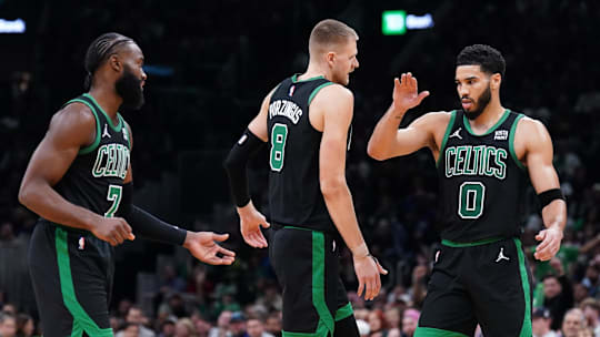 Nov 13, 2023; Boston, Massachusetts, USA; Boston Celtics forward Jayson Tatum (0), center Kristaps Porzingis (8) and guard Jaylen Brown (7) react after a play against th eNew York Knicks in the second quarter at TD Garden. Mandatory Credit: David Butler II-Imagn Images