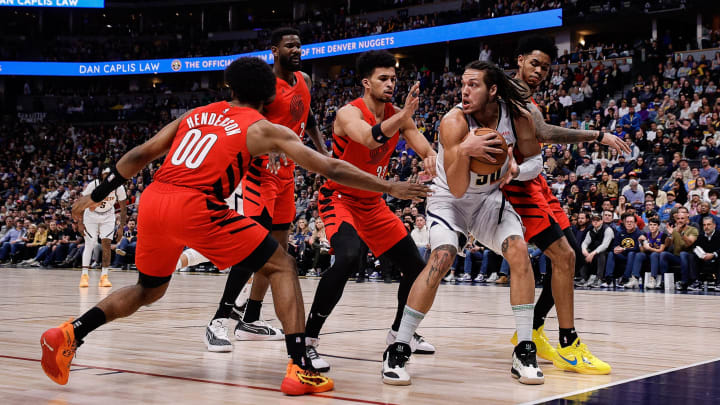 Feb 4, 2024; Denver, Colorado, USA; Denver Nuggets forward Aaron Gordon (50) controls the ball under pressure from Portland Trail Blazers guard Scoot Henderson (00) and center Deandre Ayton (2) and forward Toumani Camara (33) and guard Anfernee Simons (1) in the first quarter at Ball Arena. Mandatory Credit: Isaiah J. Downing-USA TODAY Sports