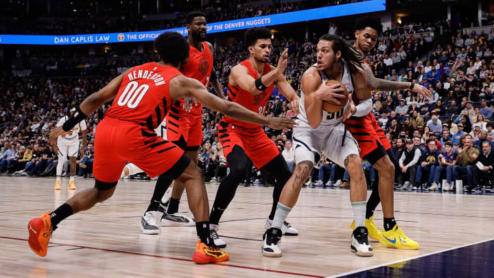 Feb 4, 2024; Denver, Colorado, USA; Denver Nuggets forward Aaron Gordon (50) controls the ball under pressure from Portland Trail Blazers guard Scoot Henderson (00) and center Deandre Ayton (2) and forward Toumani Camara (33) and guard Anfernee Simons (1) in the first quarter at Ball Arena. Mandatory Credit: Isaiah J. Downing-USA TODAY Sports