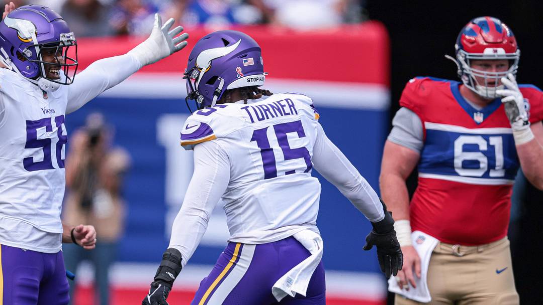 Sep 8, 2024; East Rutherford, New Jersey, USA; Minnesota Vikings linebacker Jonathan Greenard (58) celebrates a sack with linebacker Dallas Turner (15) during the first half against the New York Giants at MetLife Stadium.
