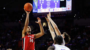 Jan 25, 2025; Gainesville, Florida, USA; Georgia Bulldogs forward Asa Newell (14) shoots over Florida Gators forward Alex Condon (21) during the first half at Exactech Arena at the Stephen C. O'Connell Center. Mandatory Credit: Matt Pendleton-Imagn Images