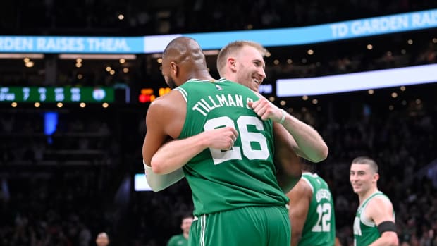 Xavier Tillman Sr. and Sam Hauser hug each other in celebration after the Boston Celtics' win over the Sacramento Kings.