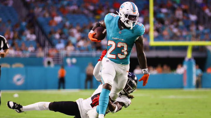 Miami Dolphins running back Jeff Wilson Jr. (23) runs with the football past Atlanta Falcons safety Lukas Denis (41) during the first quarter at Hard Rock Stadium.