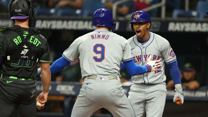 May 4, 2024; St. Petersburg, Florida, USA;  New York Mets outfielder Brandon Nimmo (9) is congratulated by shortstop Francisco Lindor (12) after he scored against the Tampa Bay Rays during the first inning at Tropicana Field. Mandatory Credit: Kim Klement Neitzel-USA TODAY Sports
