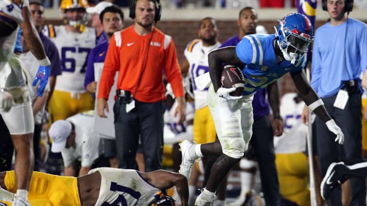 Sep 30, 2023; Oxford, Mississippi, USA; Mississippi Rebels running back Ulysses Bentley IV (24) is tripped up by LSU Tigers defensive back Andre' Sam (14) during the second half at Vaught-Hemingway Stadium. Mandatory Credit: Petre Thomas-USA TODAY Sports