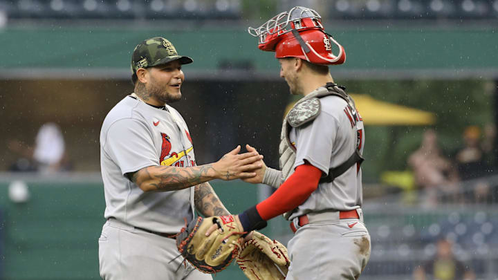 May 22, 2022; Pittsburgh, Pennsylvania, USA;  St. Louis Cardinals catchers Yadier Molina (left) and Andrew Knizner (right) celebrate after defeating the Pittsburgh Pirates at PNC Park. The Cardinals won 18-4. Mandatory Credit: Charles LeClaire-Imagn Images