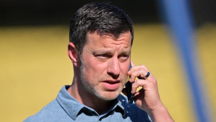 May 12, 2022; Los Angeles, California, USA; Los Angeles Dodgers president of baseball operations Andrew Friedman talks on his phone on the field before the game against the Philadelphia Phillies at Dodger Stadium. Mandatory Credit: Jayne Kamin-Oncea-USA TODAY Sports