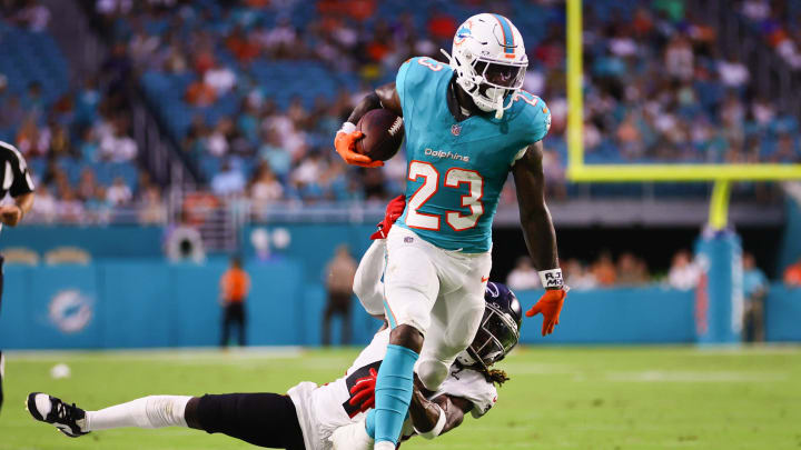 Miami Dolphins running back Jeff Wilson Jr. (23) runs with the football past Atlanta Falcons safety Lukas Denis (41) during the first quarter at Hard Rock Stadium in the preseason opener.