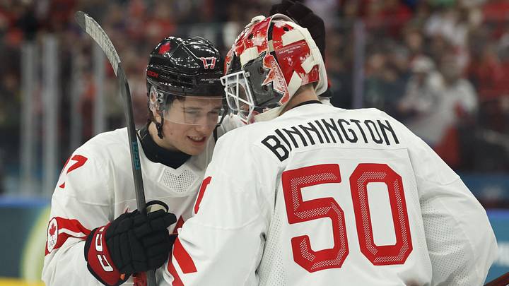 Feb 12, 2026; Milan, Italy; Macklin Celebrini and Jordan Binnington of Canada celebrate after the match against Czechia in a men's ice hockey group A match during the Milano Cortina 2026 Olympic Winter Games at Milano Santagiulia Ice Hockey Arena. Mandatory Credit: Geoff Burke-Imagn Images