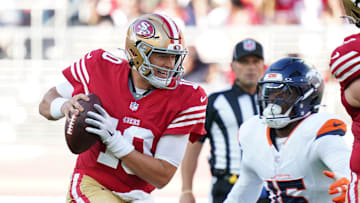 Aug 9, 2025; Santa Clara, California, USA;  San Francisco 49ers quarterback Mac Jones (10) scrambles away from Denver Broncos outside linebacker Nik Bonitto (15) in the first quarter at Levi's Stadium. Mandatory Credit: David Gonzales-Imagn Images