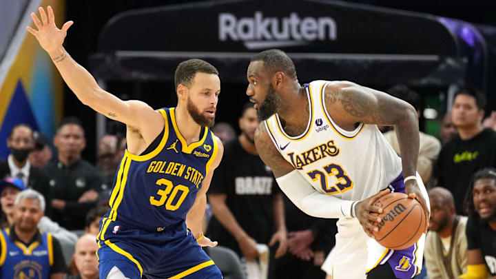 Jan 27, 2024; San Francisco, California, USA; Los Angeles Lakers forward LeBron James (23) handles the ball against Golden State Warriors guard Stephen Curry (30) during overtime at Chase Center. Mandatory Credit: Darren Yamashita-Imagn Images