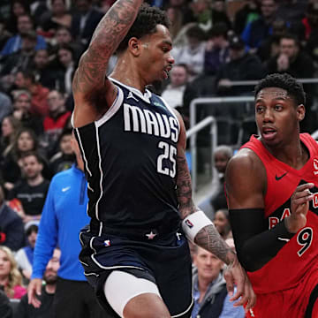Feb 28, 2024; Toronto, Ontario, CAN; Toronto Raptors guard RJ Barrett (9) controls the ball as Dallas Mavericks forward P.J. Washington (25) tries to defend during the third quarter at Scotiabank Arena. Mandatory Credit: Nick Turchiaro-Imagn Images