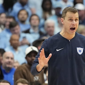 Duke basketball head coach Jon Scheyer versus UNC