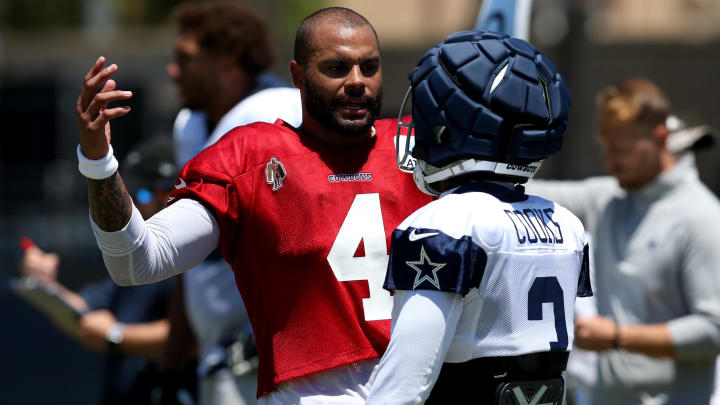 Jul 30, 2024; Oxnard, CA, USA; Dallas Cowboys quarterback Dak Prescott (4) talks to wide receiver Brandin Cooks (3) during training camp at the River Ridge Playing Fields in Oxnard, California. 