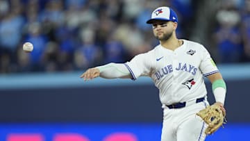 Toronto Blue Jays designated hitter Bo Bichette (11) throws to first for an out against Los Angeles Dodgers second baseman Tommy Edman (25) in the eighth inning during game seven of the 2025 MLB World Series at Rogers Centre. 
