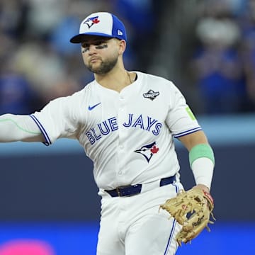 Toronto Blue Jays designated hitter Bo Bichette (11) throws to first for an out against Los Angeles Dodgers second baseman Tommy Edman (25) in the eighth inning during game seven of the 2025 MLB World Series at Rogers Centre. 