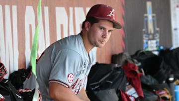 Jun 16, 2025; Omaha, Neb, USA;  Arkansas Razorbacks starting pitcher Gage Wood (14) waits in the dugout before the ninth inning against the Murray State Racers at Charles Schwab Field.