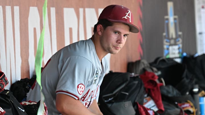 Jun 16, 2025; Omaha, Neb, USA;  Arkansas Razorbacks starting pitcher Gage Wood (14) waits in the dugout before the ninth inning against the Murray State Racers at Charles Schwab Field.