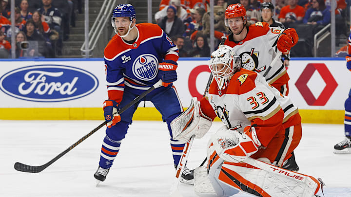 Jan 26, 2026; Edmonton, Alberta, CAN; Edmonton Oilers forward Zach Hyman (18) looks for a loose puck beside Anaheim Ducks goaltender Ville Husso (33) during the first period at Rogers Place. Mandatory Credit: Perry Nelson-Imagn Images