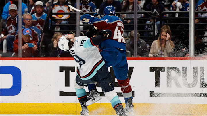 Apr 20, 2023; Denver, Colorado, USA; Seattle Kraken left wing Jared McCann (19) is hit by Colorado Avalanche defenseman Josh Manson (42) in the first period in game two of the first round of the 2023 Stanley Cup Playoffs at Ball Arena. Mandatory Credit: Isaiah J. Downing-Imagn Images