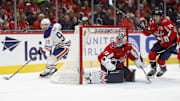 Feb 23, 2025; Washington, District of Columbia, USA; Edmonton Oilers center Connor McDavid (97) skates with the puck behind Washington Capitals goaltender Charlie Lindgren (79) in the second period at Capital One Arena. Mandatory Credit: Geoff Burke-Imagn Images