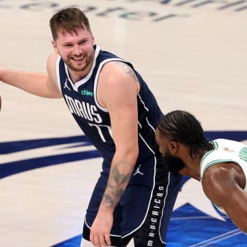Jun 12, 2024; Dallas, Texas, USA; Dallas Mavericks guard Luka Doncic (77) reacts while dribbles the ball against Boston Celtics guard Jaylen Brown (7) during the third quarter during game three of the 2024 NBA Finals at American Airlines Center. Mandatory Credit: Kevin Jairaj-USA TODAY Sports