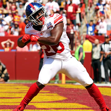 Sep 15, 2024; Landover, Maryland, USA; New York Giants running back Devin Singletary (26) celebrates after scoring a touchdown during the first quarter against the Washington Commanders at Commanders Field.  