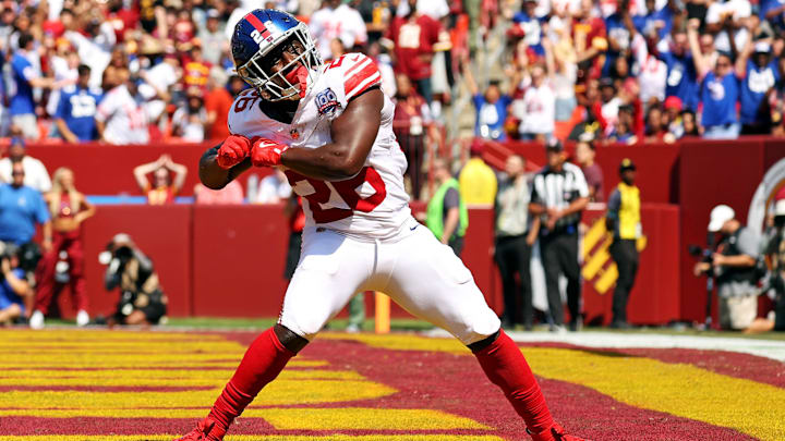 Sep 15, 2024; Landover, Maryland, USA; New York Giants running back Devin Singletary (26) celebrates after scoring a touchdown during the first quarter against the Washington Commanders at Commanders Field.  