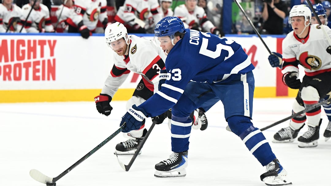 Feb 28, 2026; Toronto, Ontario, CAN;  Toronto Maple Leafs forward Easton Cowan (53) stickhandles the puck past Ottawa Senators defenseman Nick Jensen (3) in the third period at Scotiabank Arena. Mandatory Credit: Dan Hamilton-Imagn Images