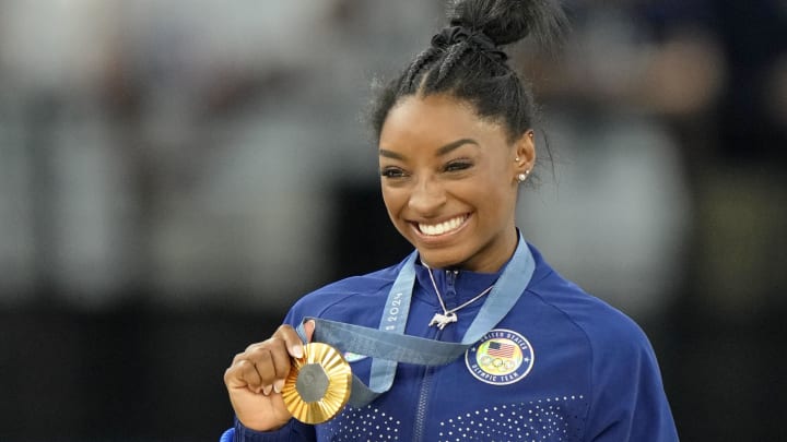 Simone Biles celebrates after winning the gold medal in the women's gymnastics all-around during the Paris 2024 Olympic Summer Games at Bercy Arena.