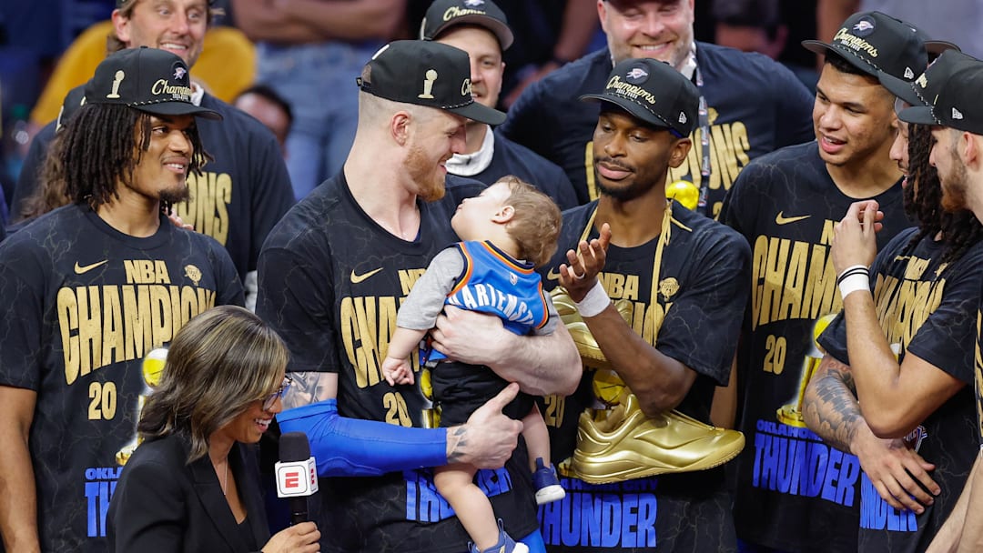Jun 22, 2025; Oklahoma City, Oklahoma, USA; Oklahoma City Thunder center Isaiah Hartenstein (55) holds his son during the NBA Championship trophy presentation after game seven of the 2025 NBA Finals against the Indiana Pacers at Paycom Center. Mandatory Credit: Alonzo Adams-Imagn Images