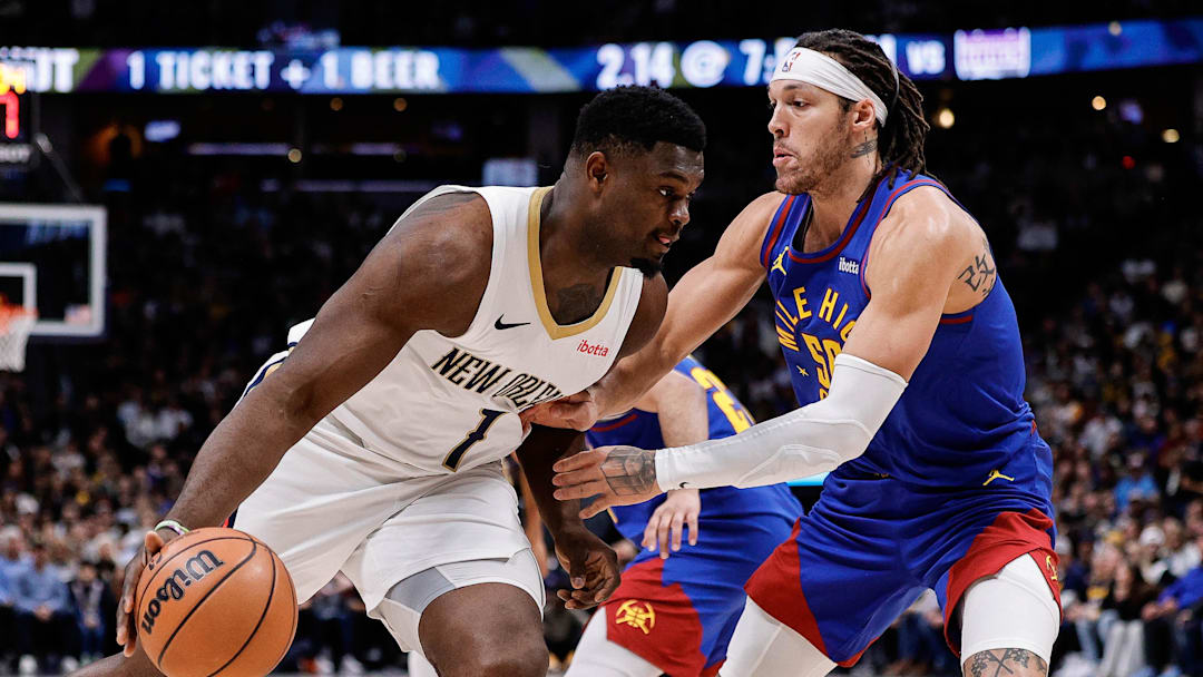 Jan 12, 2024; Denver, Colorado, USA; New Orleans Pelicans forward Zion Williamson (1) controls the ball as Denver Nuggets forward Aaron Gordon (50) guards in the first quarter at Ball Arena. Mandatory Credit: Isaiah J. Downing-Imagn Images