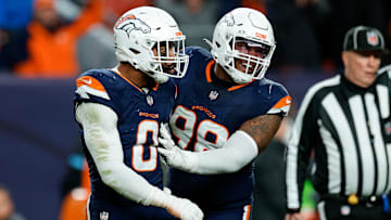 Dec 2, 2024; Denver, Colorado, USA; Denver Broncos linebacker Jonathon Cooper (0) reacts with defensive end John Franklin-Myers (98) after a play in the fourth quarter against the Cleveland Browns at Empower Field at Mile High. Mandatory Credit: Isaiah J. Downing-Imagn Images