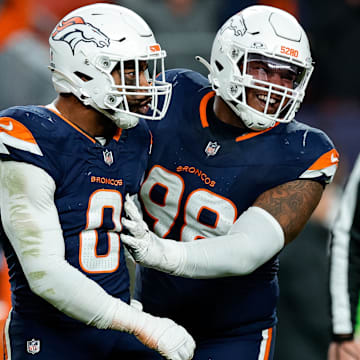 Dec 2, 2024; Denver, Colorado, USA; Denver Broncos linebacker Jonathon Cooper (0) reacts with defensive end John Franklin-Myers (98) after a play in the fourth quarter against the Cleveland Browns at Empower Field at Mile High. Mandatory Credit: Isaiah J. Downing-Imagn Images
