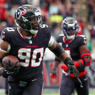 Nov 9, 2025; Houston, Texas, USA; Houston Texans defensive tackle Sheldon Rankins (90) runs for a touchdown after recovering a fumble by the Jacksonville Jaguars during the second half at NRG Stadium. Mandatory Credit: Thomas Shea-Imagn Images