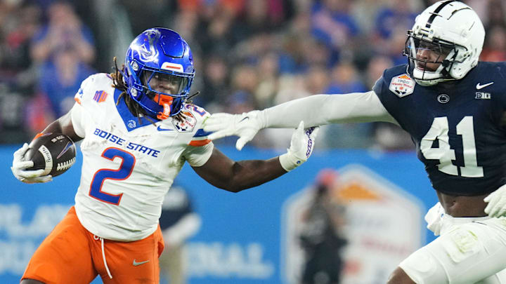Boise State Broncos running back Ashton Jeanty (2) runs past Penn State Nittany Lions linebacker Kobe King (41) during their Vrbo Fiesta Bowl matchup at State Farm Stadium on Dec. 31, 2024.