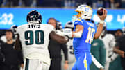 Dec 8, 2025; Inglewood, California, USA;  Los Angeles Chargers quarterback Justin Herbert (10) throws against Philadelphia Eagles defensive tackle Jordan Davis (90) in the second half at SoFi Stadium. 