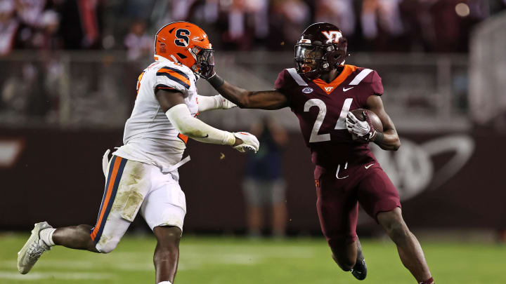 Oct 26, 2023; Blacksburg, Virginia, USA; Virginia Tech Hokies running back Malachi Thomas (24) runs the ball against Syracuse Orange linebacker Marlowe Wax (2) during the fourth quarter Lane Stadium. Mandatory Credit: Peter Casey-USA TODAY Sports