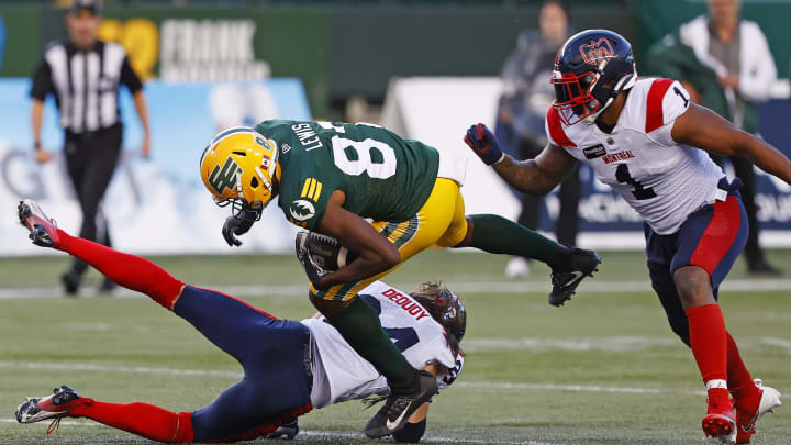 Jun 14, 2024; Edmonton, Alberta, CAN; Edmonton Elks wide receiver Eugene Lewis (87) tries to jump over Montreal Alouettes defensive back Marc-Antoine Dequoy (24) during the second half at Commonwealth Stadium. Mandatory Credit: Perry Nelson-USA TODAY Sports