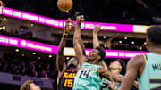Nov 30, 2024; Charlotte, North Carolina, USA; Atlanta Hawks center Clint Capela (15) and Charlotte Hornets forward Moussa Diabate (14) battle for the ball during the first quarter at Spectrum Center. Mandatory Credit: Scott Kinser-Imagn Images