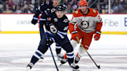 Jan 2, 2025; Winnipeg, Manitoba, CAN; Winnipeg Jets center Cole Perfetti (91) is chased down by Anaheim Ducks center Isac Lundestrom (21) the second period at Canada Life Centre. Mandatory Credit: James Carey Lauder-Imagn Images