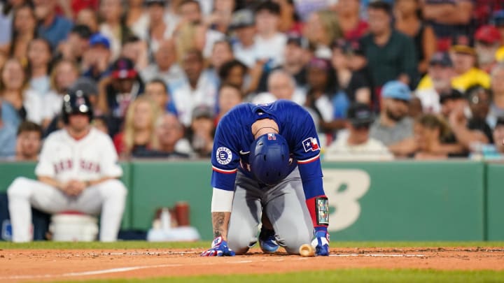 Aug 12, 2024; Boston, Massachusetts, USA; Texas Rangers catcher Jonah Heim (28) is hit by a pitch against the Boston Red Sox in the third inning at Fenway Park. Mandatory Credit: David Butler II-USA TODAY Sports