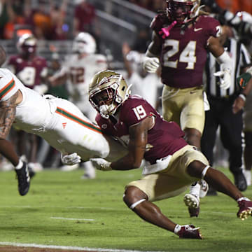 Miami wide receiver CJ Daniels scores a touchdown against Florida State defensive back Jerry Wilson.