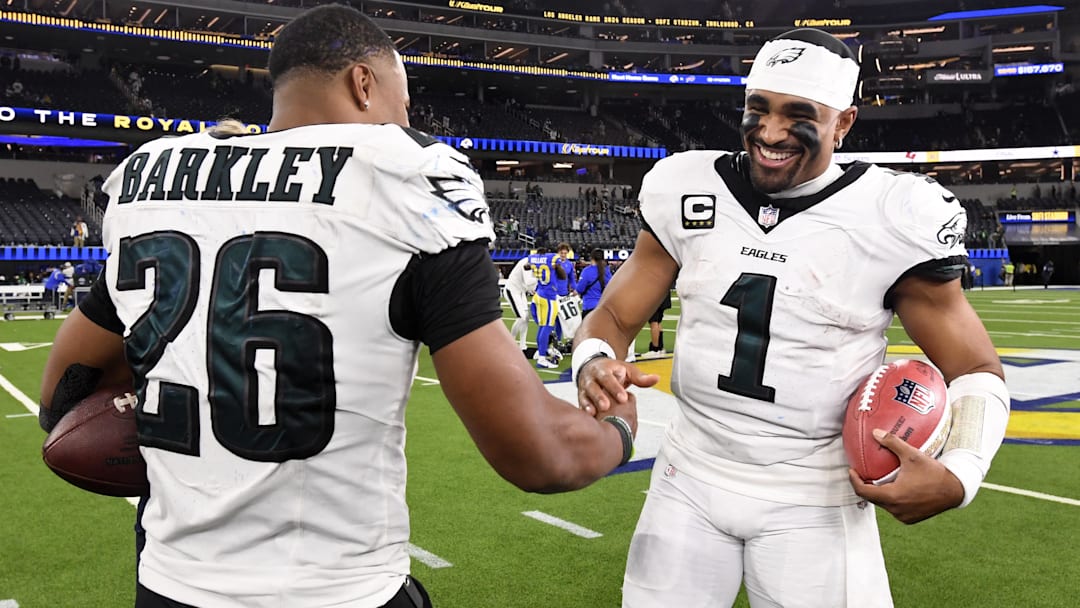 Nov 24, 2024; Inglewood, California, USA;  Philadelphia Eagles quarterback Jalen Hurts (1) celebrates with running back Saquon Barkley (26) after the Eagles defeat the Los Angeles Rams during the first half at SoFi Stadium. Mandatory Credit: Alex Gallardo-Imagn Images