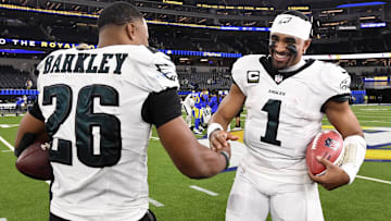 Nov 24, 2024; Inglewood, California, USA;  Philadelphia Eagles quarterback Jalen Hurts (1) celebrates with running back Saquon Barkley (26) after the Eagles defeat the Los Angeles Rams during the first half at SoFi Stadium. Mandatory Credit: Alex Gallardo-Imagn Images