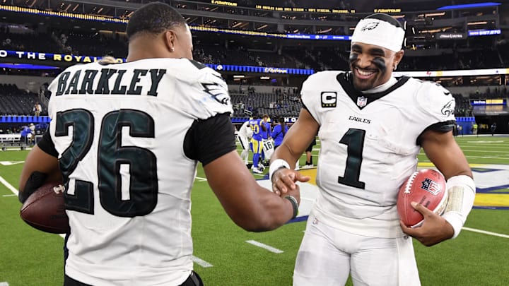 Nov 24, 2024; Inglewood, California, USA;  Philadelphia Eagles quarterback Jalen Hurts (1) celebrates with running back Saquon Barkley (26) after the Eagles defeat the Los Angeles Rams during the first half at SoFi Stadium. Mandatory Credit: Alex Gallardo-Imagn Images