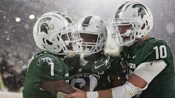 Nov 27, 2021; East Lansing, Michigan, USA; Michigan State Spartans wide receiver Jayden Reed (1) celebrates with running back Kenneth Walker III (9) and quarterback Payton Thorne (10) after making a touchdown catch during the fourth quarter against the Penn State Nittany Lions at Spartan Stadium. Mandatory Credit: Raj Mehta-Imagn Images
